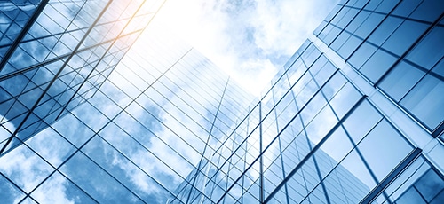 glass,buildings,with,cloudy,blue,sky,background
