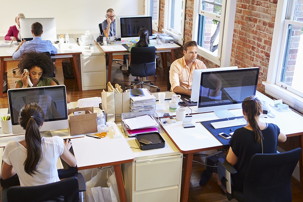 wide,angle,view,of,busy,design,office,with,workers,at